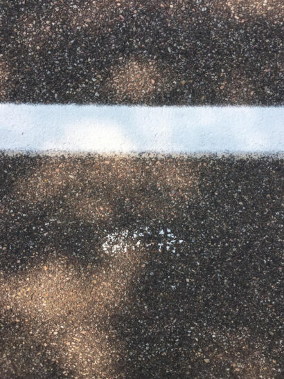 Image of a footprint via Gabrielle Bates and Jennifer S Cheng's collaboration, with a white line on the ground