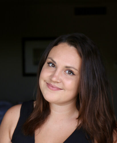 Kaija smiling with brown hair in a black shirt.