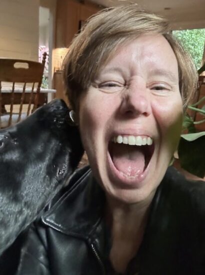 Linda Drach laughing with her dog