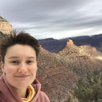 Veronica smiling with brown hair in front of canyons