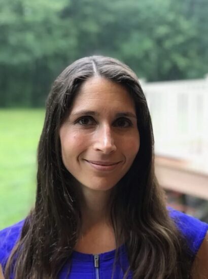 Jana-Lee smiling with brown hair in a blue shirt