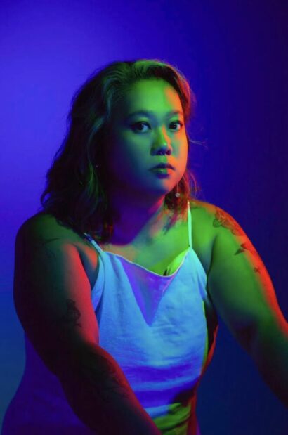 Ina in a tank top in blue light