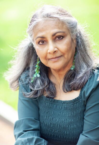 Shaheen with gray hair wearing a blue shirt