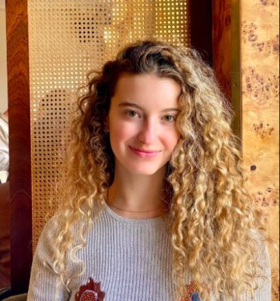 Photo of Jessica Smiling in a Sunny Corner