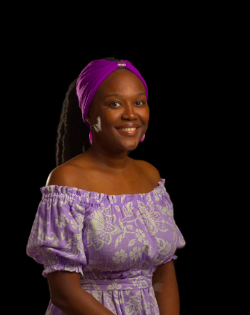 Photograph of Theresa Sylvester in a purple dress and head wrap in a black studio