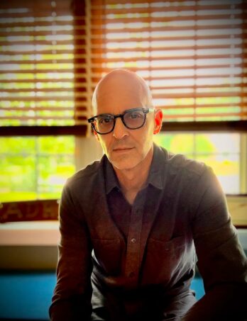 Christopher in a sunny room with the blinds open