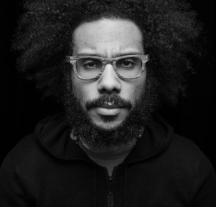 Quenton in a studio staring at the camera