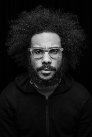 Quenton in a studio staring at the camera