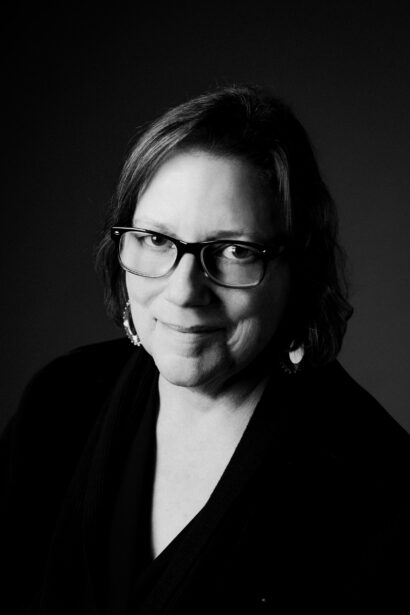 Author Ruby Murray poses in a black and white photo, smiling slightly into the camera
