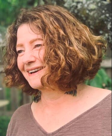 Stephanie Striffler outside, smiling and laughing